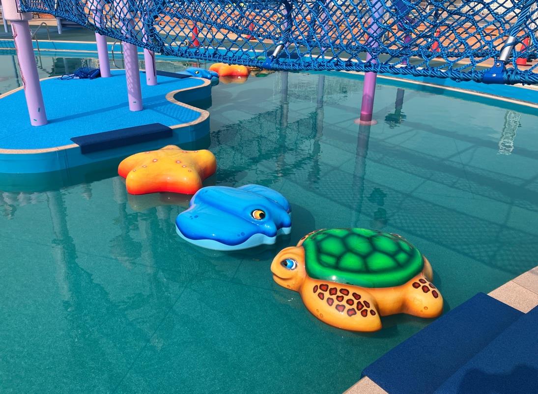 Colorful sea-life Water-Walk play system installed over a pool