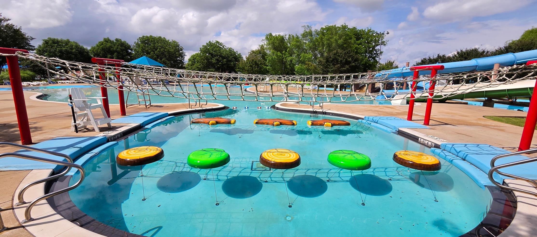 A colorful BoMar Water-Walk installed across a commercial pool